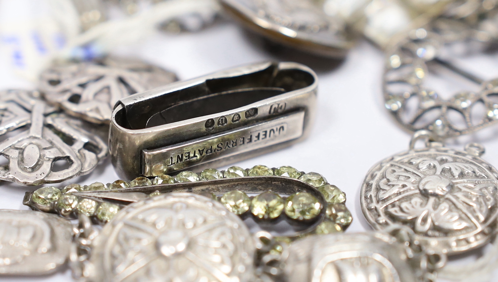 A pair of paste set 925 shoe buckles, 31mm, a George V silver bracelet, a set of four Edwardian silver buttons, two paste set white metal buttons, a Victorian silver patent clip, and other sundry items including a silver